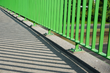 closeup-base-green-barrier-overpass-bridge